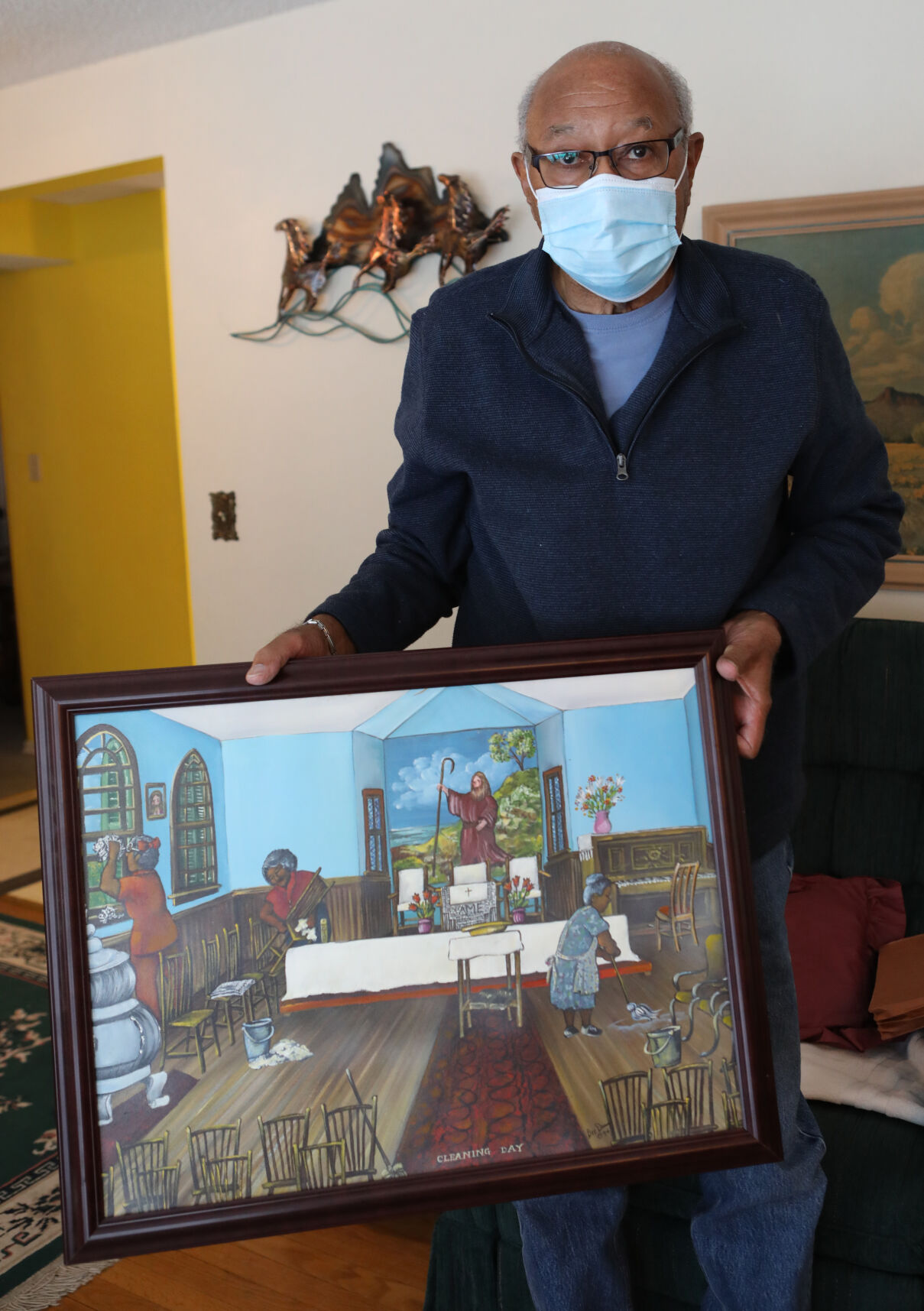 David Smith holds a painting of Anna Bell Chapel